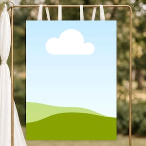 Puede incluir: Un letrero rectangular con un diseño de cielo y nube, colgado de un marco de metal dorado. El letrero presenta un cielo azul claro, una nube blanca y colinas verdes. Cintas blancas aseguran el letrero al marco.