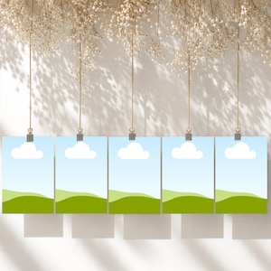 May include: Five identical rectangular cards hanging from thin strings, each featuring a graphic illustration of a light blue sky with a single white cloud above rolling green hills. The cards are suspended in a horizontal row against a wall.