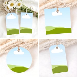 May include: A collection of gift tags with a landscape design. Each tag features a blue sky with a white cloud, and green rolling hills. The tags are in various shapes, including rectangular, square, and circular, and are attached with twine.