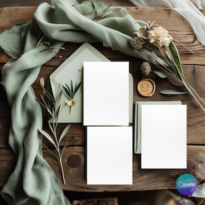 May include: A rustic wooden table displays wedding stationery. The scene includes blank white cards, a sage green envelope, a silk scarf, dried flowers, and a gold wax seal. The arrangement suggests a natural, elegant theme.