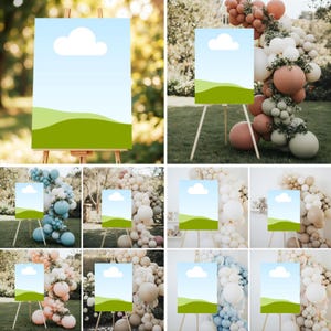 May include: A series of blank signs on wooden easels, each featuring a blue sky with a white cloud and green hills. The signs are displayed outdoors, surrounded by decorative balloon arrangements in various colors.