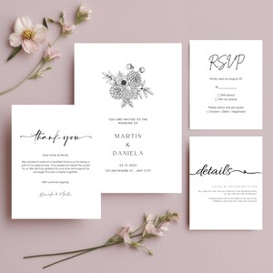 May include: A collection of white wedding stationery with elegant black script. The set includes an invitation, RSVP card, details card, and thank you note. Floral illustrations and the names "Martin & Daniela" are featured.