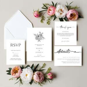 May include: A collection of white wedding stationery, including an RSVP card, invitation, thank you note, and details card. The invitation features a floral illustration and the names "Martin & Daniela." The cards are arranged with pink and white peonies and greenery.