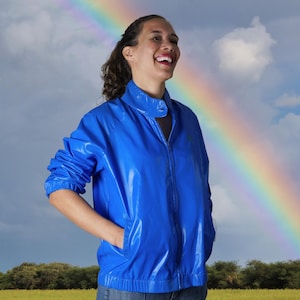 May include: A set of three ceramic mugs with a speckled, matte finish. The mugs are in shades of cream, light gray, and dark gray. Each mug has a simple, minimalist design and a rounded handle.