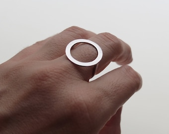 May include: A silver ring with a large, open circle design.
