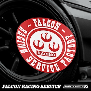 May include: A red and white circular sticker with the text "FALCON RACING SERVICE FACTORY" around the outside. The center of the sticker features a white logo with three stylized birds and the word "RACING" in white text.