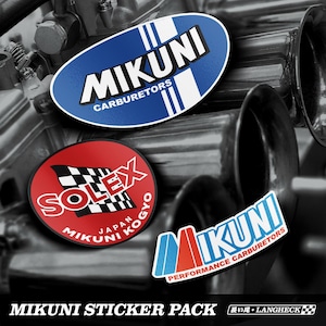 May include: A set of three vinyl stickers featuring automotive branding. One oval blue sticker reads MIKUNI CARBURETORS. A circular red sticker displays a checkered flag with SOLEX JAPAN MIKUNI KOGYO text. A third sticker reads MIKUNI PERFORMANCE CARBURETORS.