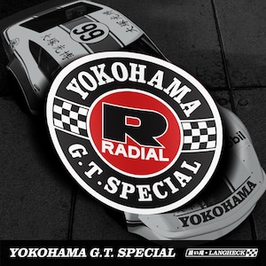 May include: A sticker with the text "YOKOHAMA G.T. SPECIAL" in white, black, and red. The sticker is circular with a checkered flag design and the number 99 on a white and black race car.