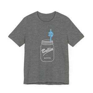 May include: A heather grey t-shirt featuring a white outline of a mason jar with a blue straw and the text "Ballin' Mason".