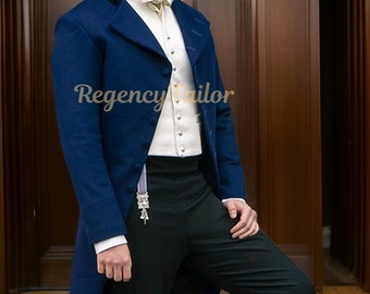 May include: A navy blue Regency-style coat with a black velvet collar, worn over a white vest and shirt. The outfit includes black trousers and a cream-colored bow tie. The text "Regency Tailor" is visible on the coat.