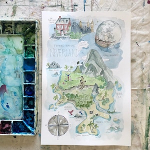 May include: A watercolor illustration of Peter Pan's Neverland, featuring a map of the island with various landmarks, including Skull Rock, Mermaid Lagoon, and Pirate's Cove. The map is surrounded by a blue sky with a full moon and a pirate ship sailing in the distance.