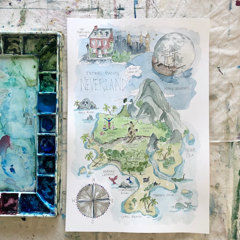 May include: A watercolor illustration of Peter Pan's Neverland, featuring a map of the island with various landmarks, including Skull Rock, Mermaid Lagoon, and Pirate's Cove. The map is surrounded by a blue sky with a full moon and a pirate ship sailing in the distance.