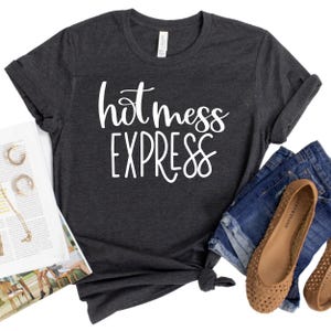 May include: A dark gray t-shirt with the text "hot mess express" in white lettering.