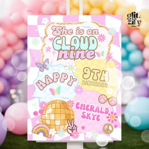 May include: A colorful birthday party sign with the text "She is on Cloud Nine" and "Happy 9th Birthday Emerald Skye." The design includes a disco ball, butterflies, flowers, and a peace sign, set against a pink and white checkered background.