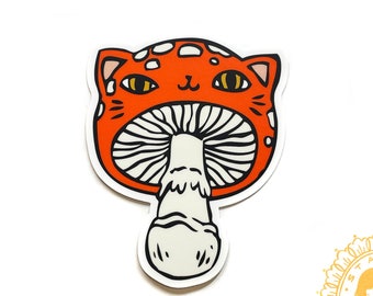 Op de afbeelding: Een vinyl sticker met een grillig ontwerp van een kat-paddenstoel hybride. De oranje kat-paddenstoel heeft witte stippen en een wit-zwart gestreepte steel. De tekst "Meowshroom" en "vinyl sticker" staan boven en onder de afbeelding, met de website stasiaburrington.com.