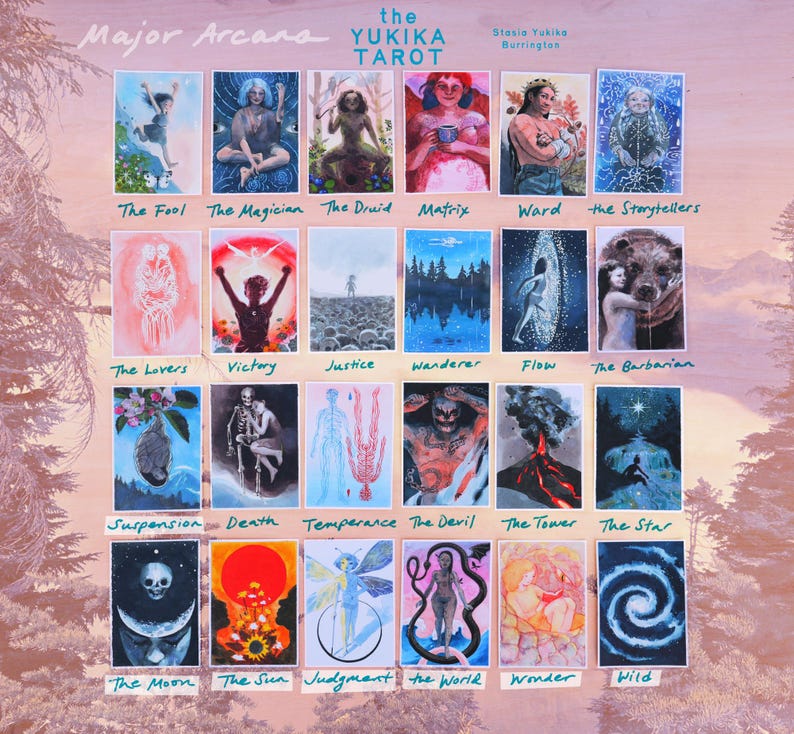 May include: A collection of twenty-four rectangular tarot cards titled The Yukika Tarot by Stasia Yukika Burrington. Each card features a unique, colorful illustration with a handwritten label below it, including titles like The Fool, The Magician, The Druid, Matrix, Ward, The Storytellers, The Lovers, Victory, Justice, Wanderer, Flow, The Barbarian, Suspension, Death, Temperance, The Devil, The Tower, The Star, The Moon, The Sun, Judgment, The World, Wonder, and Wild.