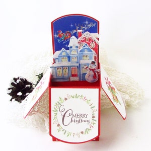 Carte pop-up de Noël, carte pop-up de Noël fantaisiste faite à la main, père Noël et rennes volant au-dessus des maisons, carte pour agent immobilier