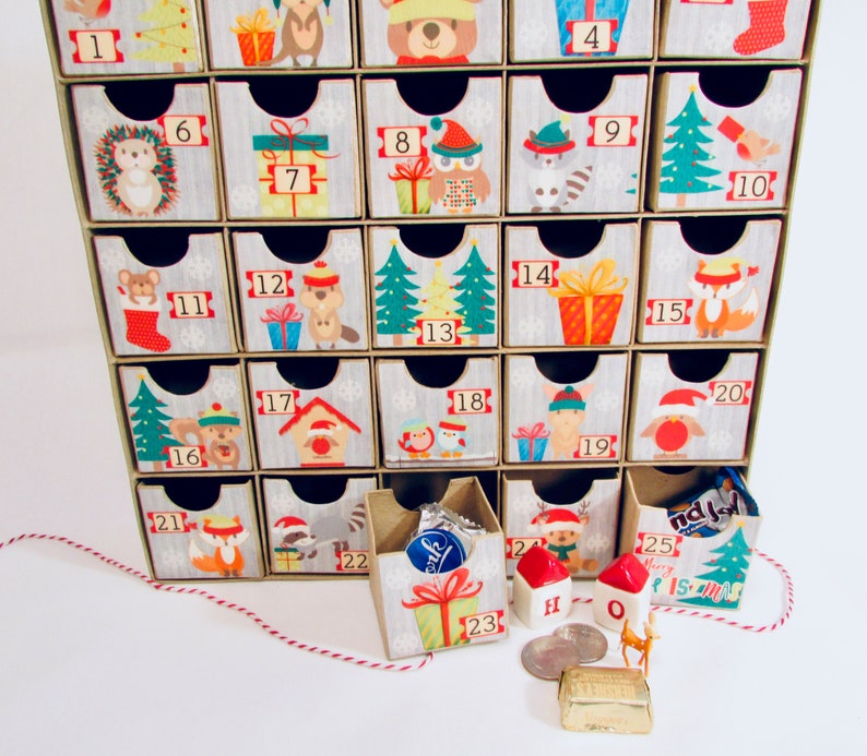 Woodland wonder animals decorate this unique handmade heirloom quality advent calendar.  A reusable year-after-year countdown to Christmas set of mini drawers will be a favorite decoration for years to come.