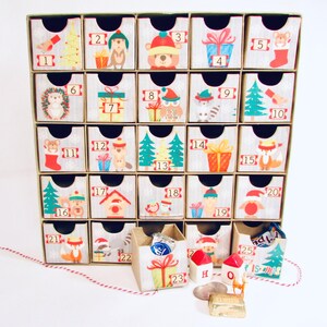 Woodland wonder animals decorate this unique handmade heirloom quality advent calendar.  A reusable year-after-year countdown to Christmas set of mini drawers will be a favorite decoration for years to come.