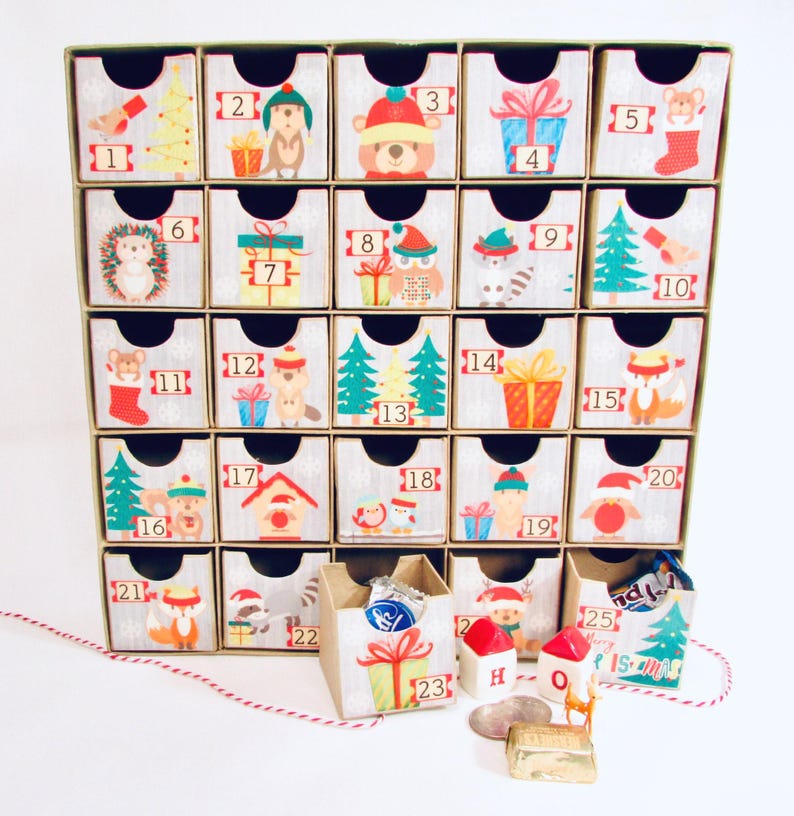 Woodland wonder animals decorate this unique handmade heirloom quality advent calendar.  A reusable year-after-year countdown to Christmas set of mini drawers will be a favorite decoration for years to come.