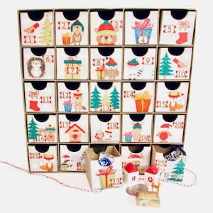 Woodland wonder animals decorate this unique handmade heirloom quality advent calendar.  A reusable year-after-year countdown to Christmas set of mini drawers will be a favorite decoration for years to come.