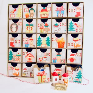 Woodland wonder animals decorate this unique handmade heirloom quality advent calendar.  A reusable year-after-year countdown to Christmas set of mini drawers will be a favorite decoration for years to come.