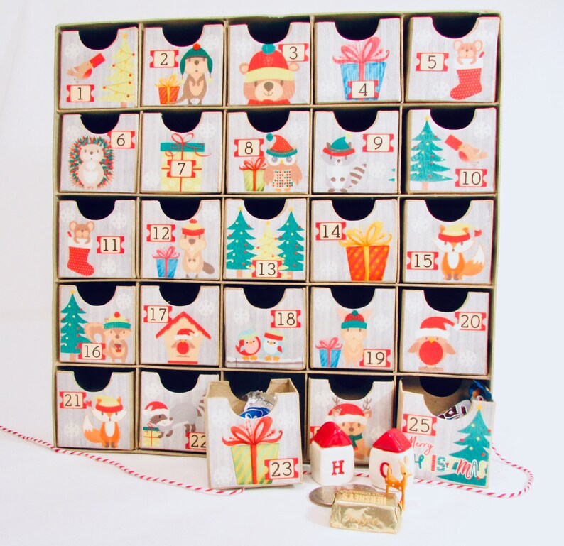 Woodland wonder animals decorate this unique handmade heirloom quality advent calendar.  A reusable year-after-year countdown to Christmas set of mini drawers will be a favorite decoration for years to come.