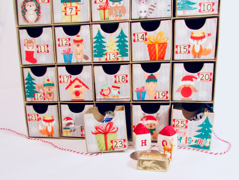 Woodland wonder animals decorate this unique handmade heirloom quality advent calendar.  A reusable year-after-year countdown to Christmas set of mini drawers will be a favorite decoration for years to come.