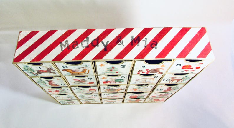 Woodland wonder animals decorate this unique handmade heirloom quality advent calendar.  A reusable year-after-year countdown to Christmas set of mini drawers will be a favorite decoration for years to come.