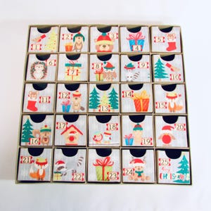 Woodland wonder animals decorate this unique handmade heirloom quality advent calendar.  A reusable year-after-year countdown to Christmas set of mini drawers will be a favorite decoration for years to come.
