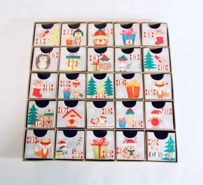 Woodland wonder animals decorate this unique handmade heirloom quality advent calendar.  A reusable year-after-year countdown to Christmas set of mini drawers will be a favorite decoration for years to come.