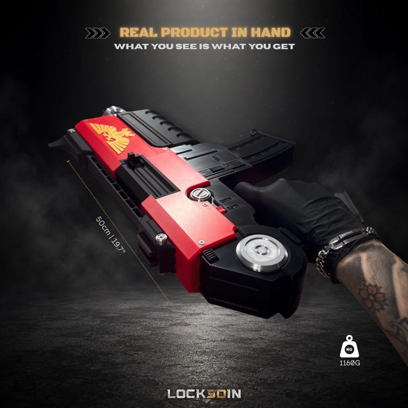 May include: A black and red prop blaster featuring a gold eagle emblem on the side. The device measures 50 cm in length and weighs 1160 g. Text on the image reads: REAL PRODUCT IN HAND, WHAT YOU SEE IS WHAT YOU GET, and LOCK3DIN.
