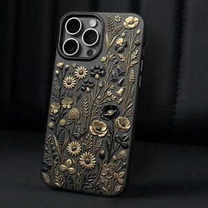May include: Black smartphone case with a gold and black floral pattern. The case has an embossed design of various flowers, leaves, and stems, giving a textured, 3D appearance. The case is designed for a smartphone.