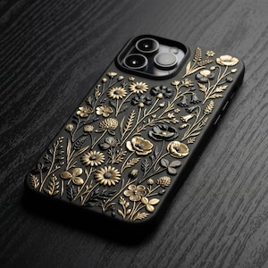 May include: Black smartphone case with a detailed floral pattern. The case has an embossed design of gold and black flowers, leaves, and stems. The case has a glossy finish and is designed for a smartphone.