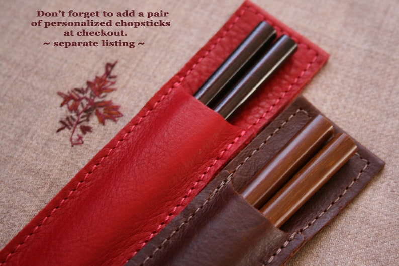 May include: Two leather chopsticks holders, one red and one brown, with chopsticks inside. The text "Don't forget to add a pair of personalized chopsticks at checkout. ~ separate listing ~" is visible in the top left corner of the image.