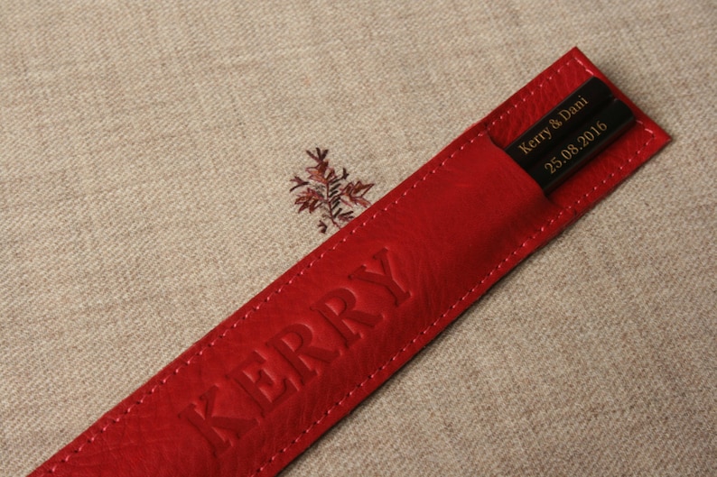 May include: Red leather chopsticks case with the name "Kerry" embossed on the front and the text "Kerry & Dani 25.08.2016" on the inside.