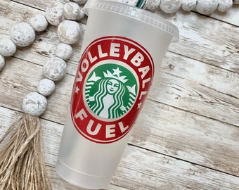 May include: A white reusable cup with a red and green Starbucks logo and the text "Volleyball Fuel".