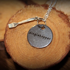May include: Silver necklace with a round pendant that says "dinglehopper" and a small fork charm.
