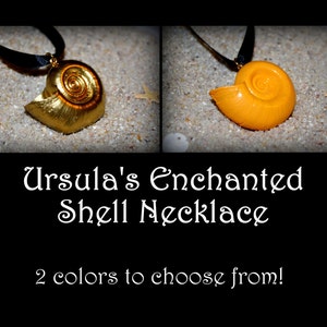 May include: Ursula's Enchanted Shell Necklace, a handmade necklace with a shell pendant in two colors: gold and orange. The necklace is on a black ribbon.