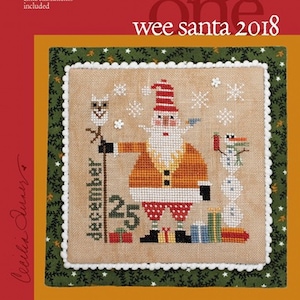 May include: A cross-stitch pattern titled "Wee Santa 2018" featuring a Santa Claus design with a snowman, gifts, and snowflakes. The design includes the text "December 25". The Heart in Hand Needleart logo is in the upper left corner.