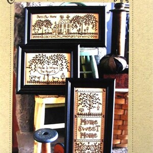 May include: Three framed blackwork embroidery patterns with a home theme. The patterns are titled "Bless Our Home", "Home Is Where The Heart Is", and "Home Sweet Home".