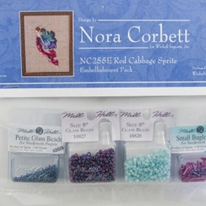 May include: A pack of four small bead containers for needlepoint projects. The containers are labeled "Petite Glass Beads", "Size 8" Glass Beads", "Size 8" Glass Beads", and "Small Bugle Beads". The beads are in shades of purple, blue, and turquoise.