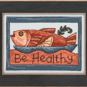 May include: A cross-stitch embroidery design featuring a red fish on a blue plate with the text "Be Healthy".