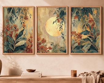 May include: A set of three rectangular wall art prints in light wood frames. The artwork features a central yellow moon surrounded by dark green foliage and orange flowers against a muted, textured background with vertical brushstroke patterns.
