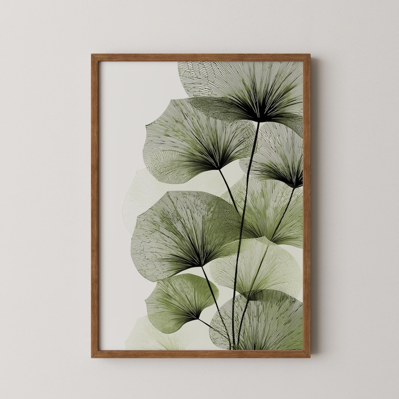 May include: A framed art print featuring stylized green fan-shaped leaves with black linear details against a cream background. The artwork is enclosed in a brown wooden frame, suitable for wall decor.