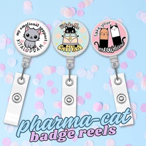 May include: Three white badge reels with cat-themed designs. One reel has a gray cat and the text "my emotional support KITALOPRAM". Another has a black cat in a van with the text "I'll take the CATIVAN". The third has two cats and the text "take your meowdicine". The words "pharma-cat badge reels" are written below.