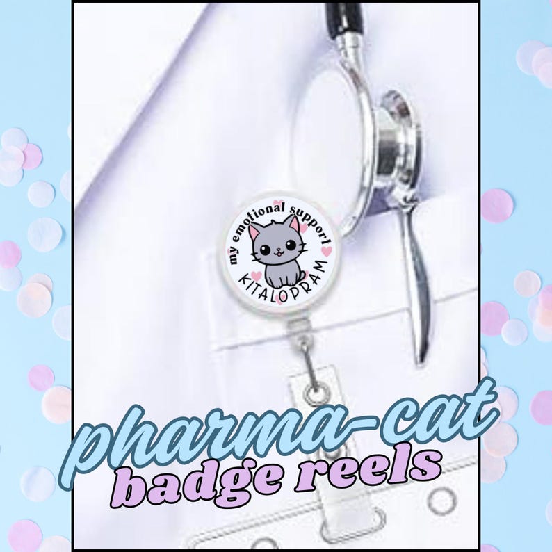 May include: A white badge reel with a cartoon cat design and the words "my emotional support" and "KITALOPRAM". The text "pharma-cat badge reels" is also displayed. A stethoscope is visible in the background.