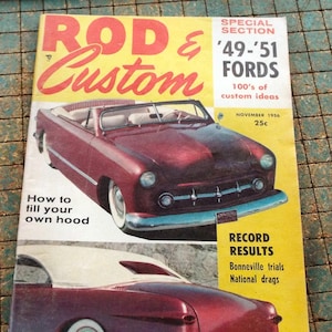 May include: A vintage "Rod & Custom" magazine cover featuring a maroon convertible Ford. The cover has a yellow background with text that reads "49-'51 FORDS" and "100's of custom ideas". The magazine is from November 1956.