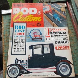 May include: Vintage October 1962 Rod & Custom magazine cover featuring a red and yellow title. The cover includes images of drag racing cars, a Corvette, and a black 'T' Coupe. Text includes "Electric Drags" and "Joe Cruces' Sweepstakes-Winning 'T' Coupe."