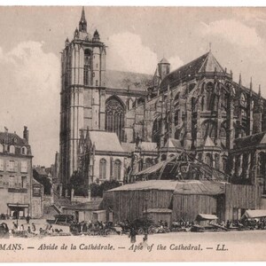 May include: A black and white vintage postcard depicting the apse of the Cathedral of Le Mans, France. The postcard includes the text "LE MANS. -Abside de la Cathédrale. -Aple of the Cathedral. -LL."